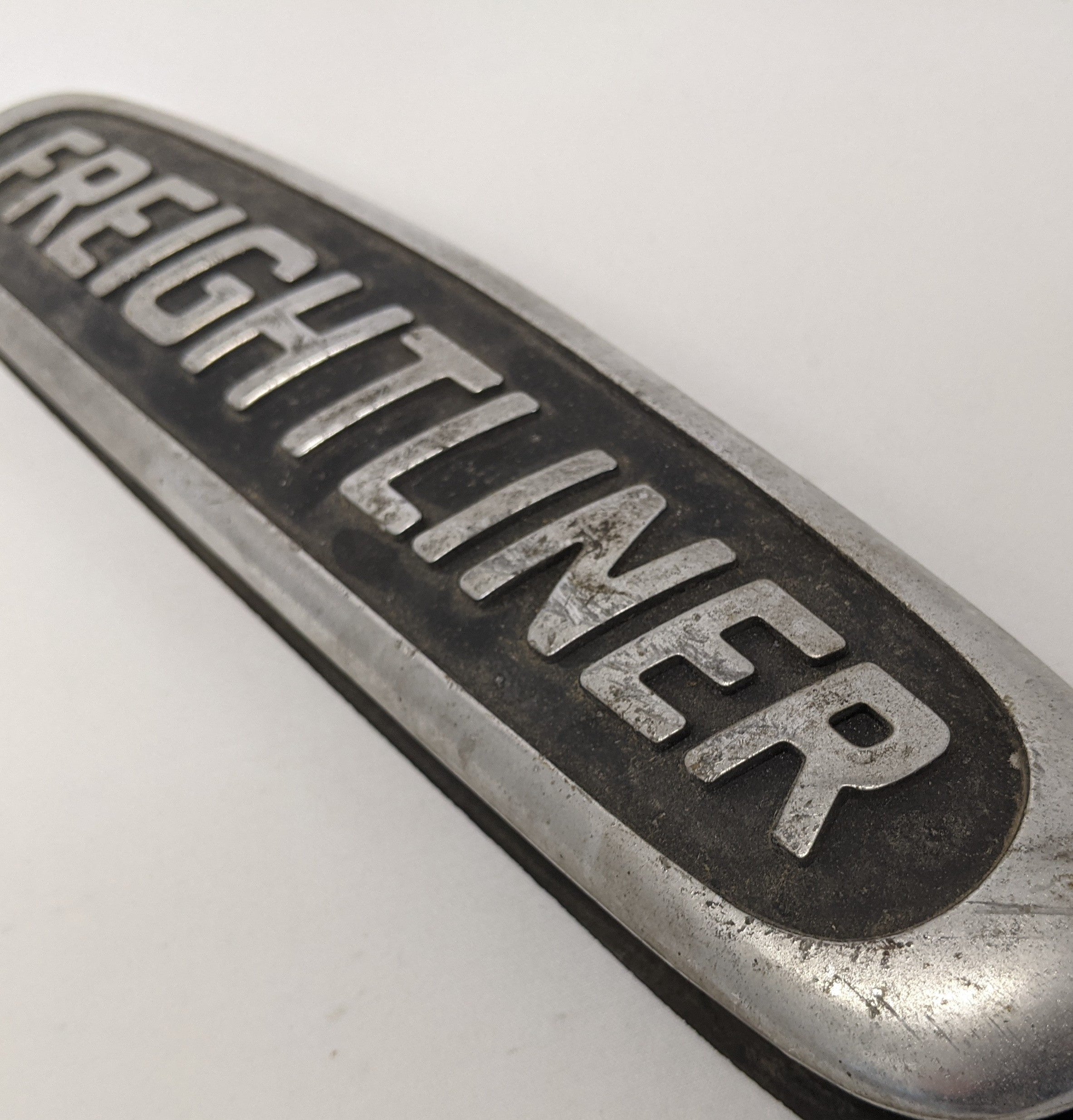 Used Freightliner 10 1/4" x 2 1/4" Aluminum Nameplate Emblem- P/N 22-45504-000 (10016230408508)