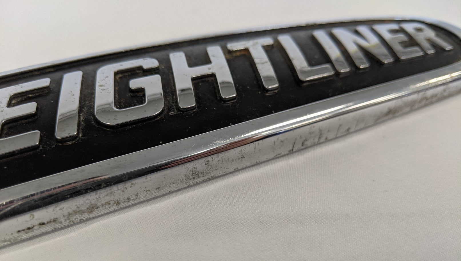 Damaged Freightliner Plastic Semi Truck Emblem - Broken Studs - P/N 22-57546-000 (4508029255766)