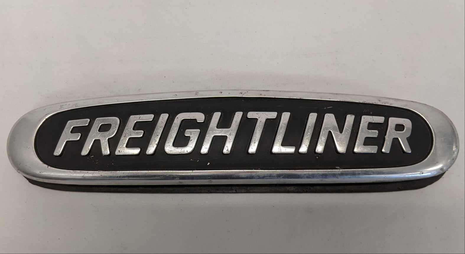 Used Freightliner 10 1/4" x 2 1/4" Aluminum Nameplate Emblem - P/N  22-45504-000 (10016209666364)